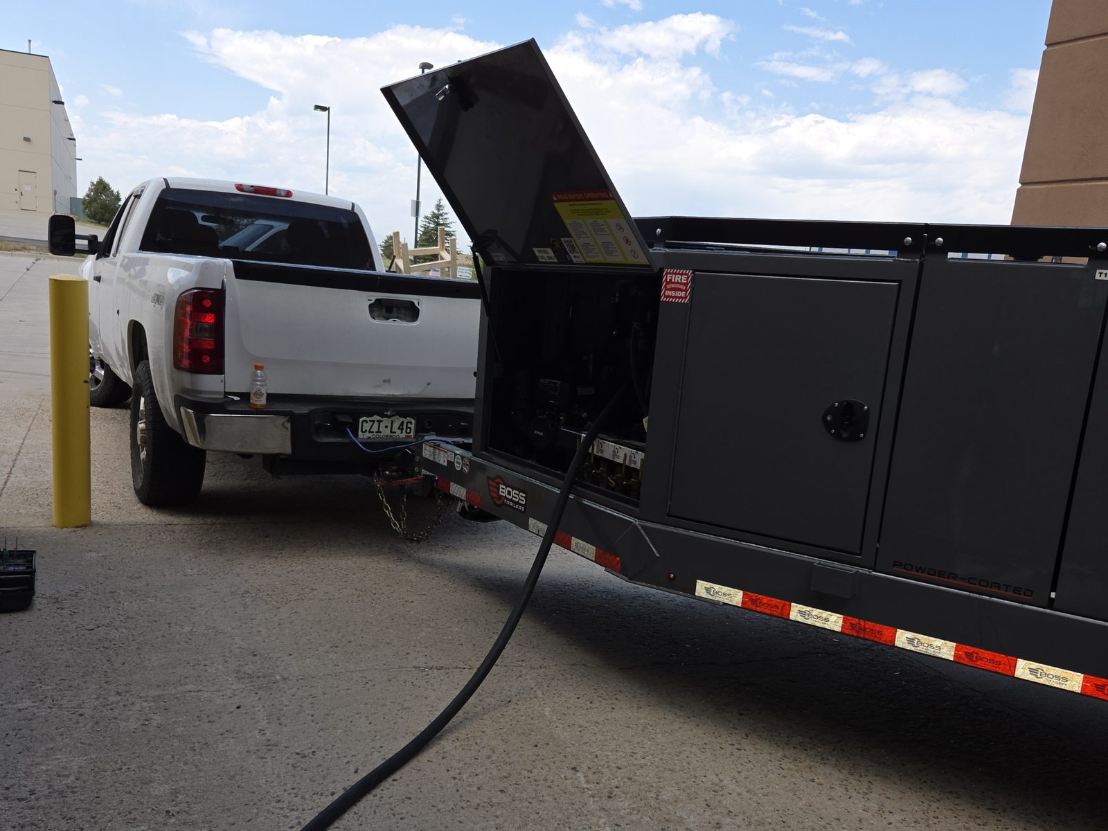 The Fuel Guys delivery trailer fueling equipment on a Denver job site.