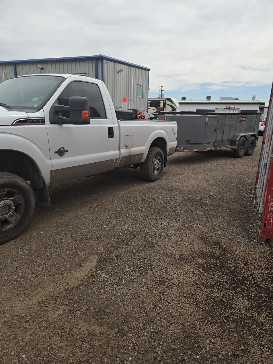 The Fuel Guys truck and fuel trailer loaded at a job site