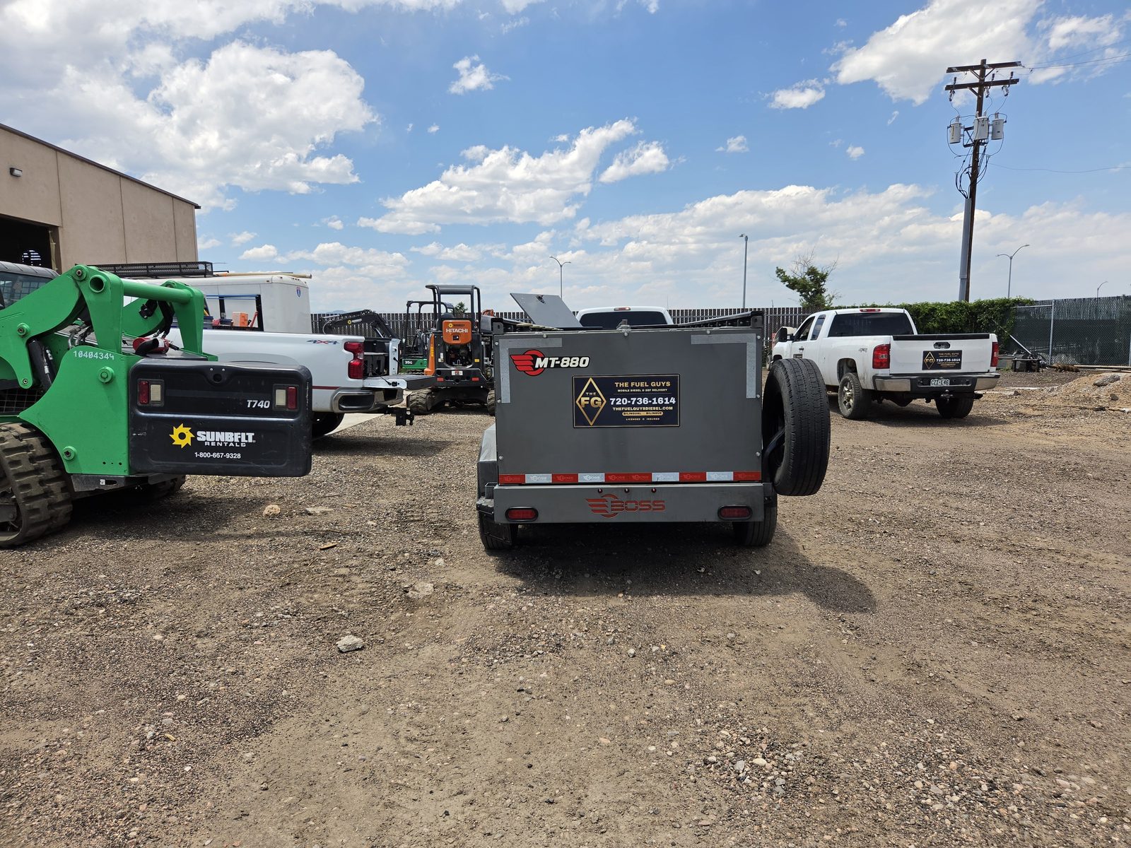 The Fuel Guys branded MT-880 fuel trailer and trucks on a job site