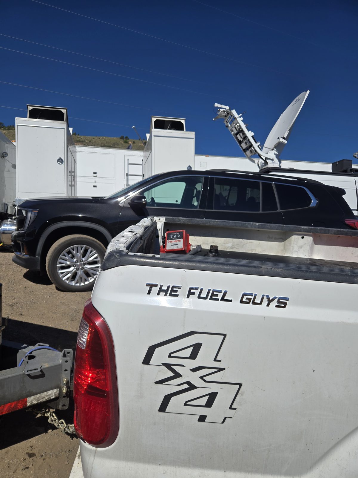 The Fuel Guys branded truck with transfer pump fueling satellite broadcast trucks at Thunder Valley Motocross Park